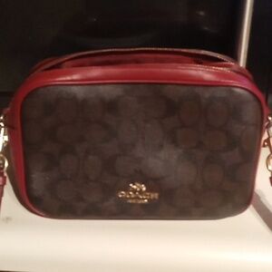 Medium size burgundy and brown coach purse